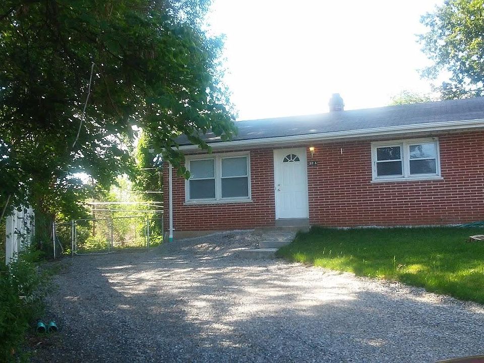 Newly graveled driveway with gate to backyard