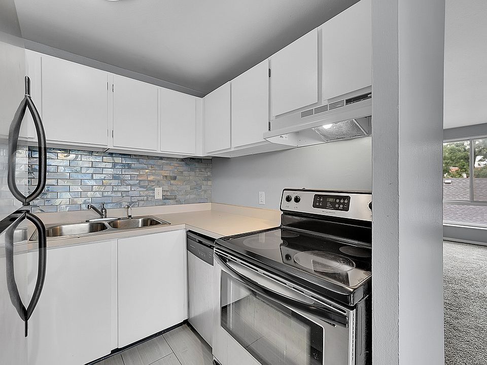 Kitchen features stainless appliances including Dishwasher and new tile backsplash.