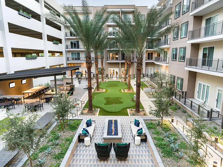 This beautifully designed courtyard offers lounge seating, a fire feature, and a putting green_ideal for relaxing or spending time with neighbors.