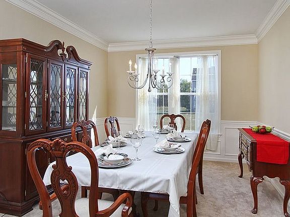 Elegant Formal Dining Room With Upgraded Crown Molding and Chair Rail
