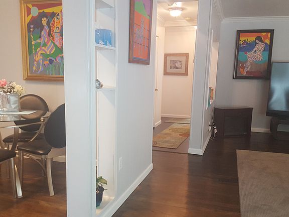 Staged example of furnished dining room and living room.