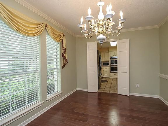 Your formal dining room with a peaceful view of your treed front yard.
