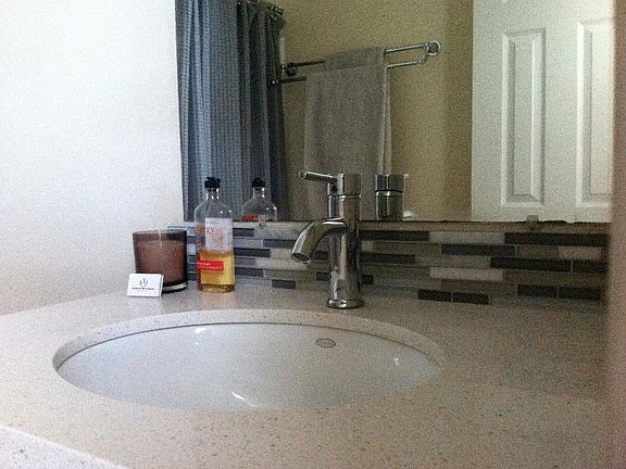 Bath- quartz countertops, glass tile backsplash