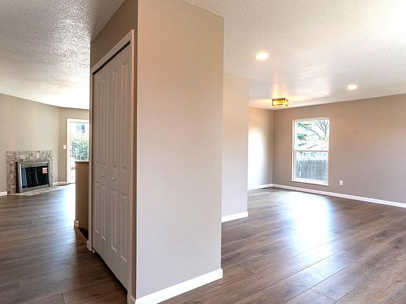 Open floorplan with Luxury Vinyl Plank flooring and neutral colors.