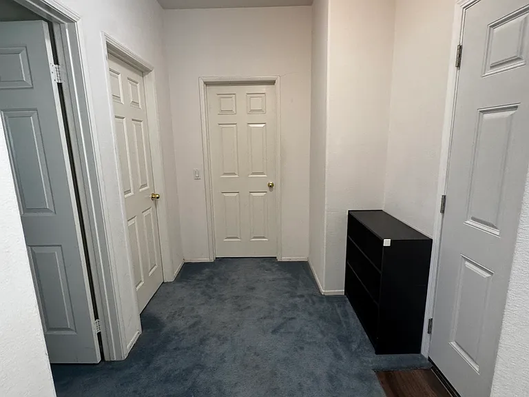 3 total bedrooms: 2 bedrooms facing West or left side of photo and 
1 bedroom in center of photo facing North. Center bedroom has own bathroom (not available at this time). Entry/exist door next to shoe rack on right side of photo.