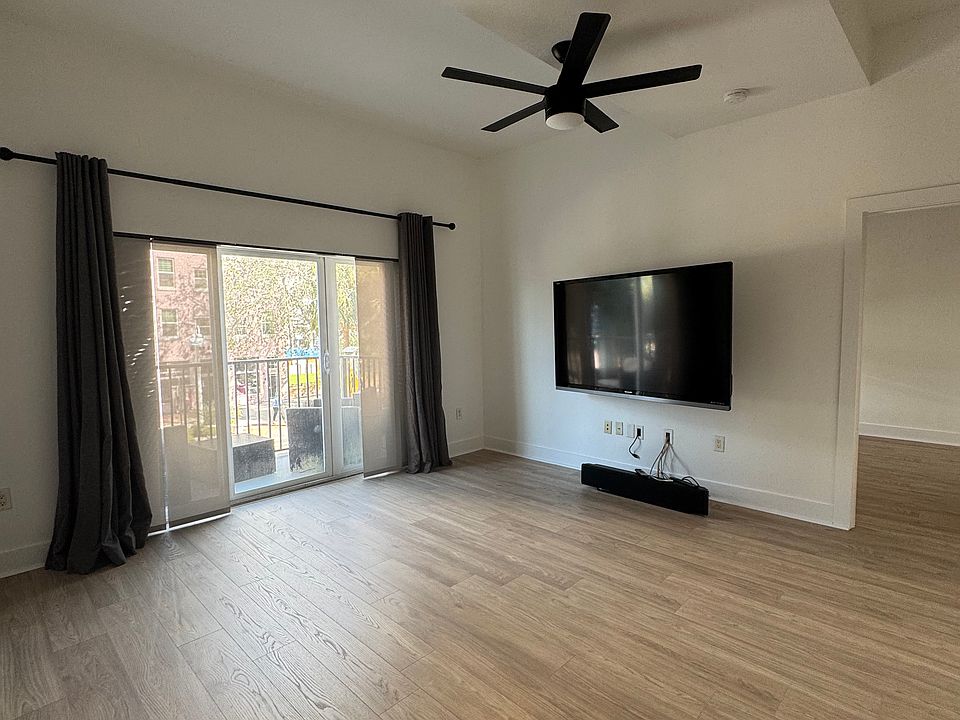 Spacious living room with a private balcony overlooking Central Avenue, nestled in the heart of the Edge District.