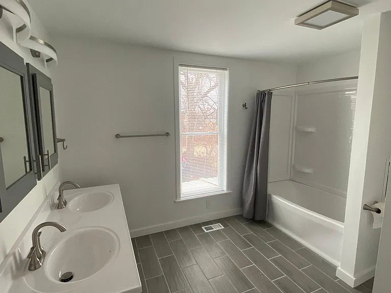 Recently remodeled and spacious upstairs full bath with double vanity.