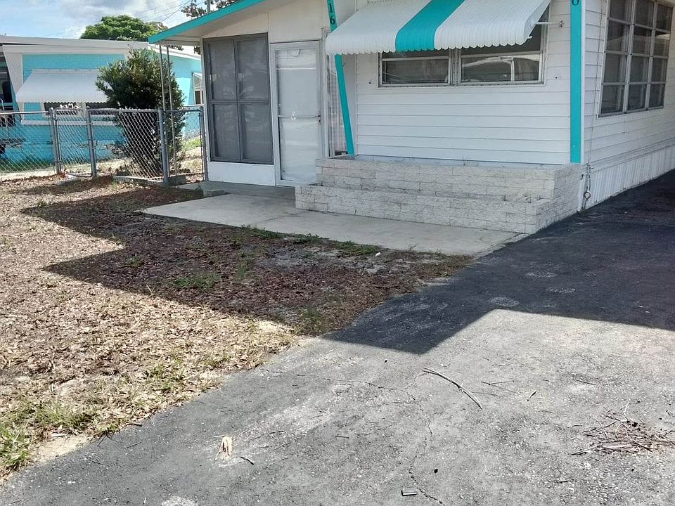 Front of house. Tall grass just cut. Will grow green.