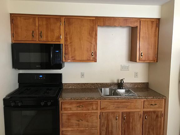 kitchen with newer stove, MW, sink, and refrigerator