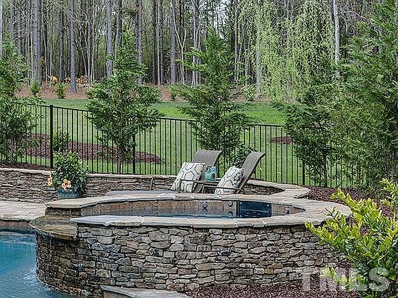 Am I on vacation? Custom features extend to the pool's hot tub fully integrated and set in a large, 