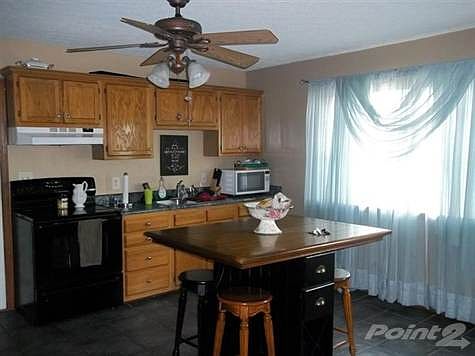 Tiled floor, lots of cabinets and separate pantry.
