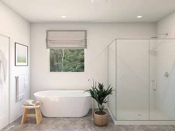 Primary bath with freestanding tub and glass shower enclosure