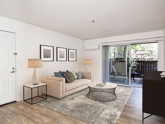 Living area with balcony access and hard surface flooring