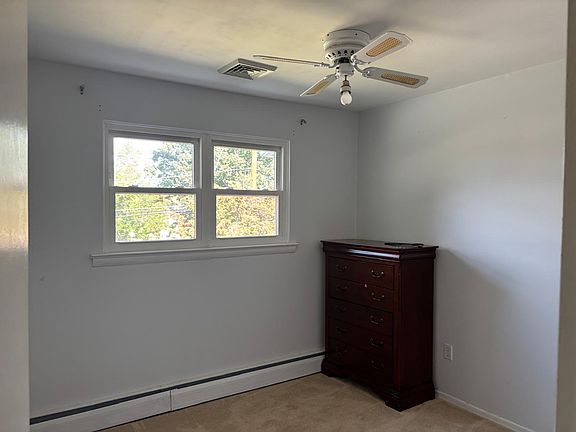 Bedroom 3. Includes a ceiling fan and closet.