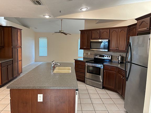 Kitchen with family room in the background.