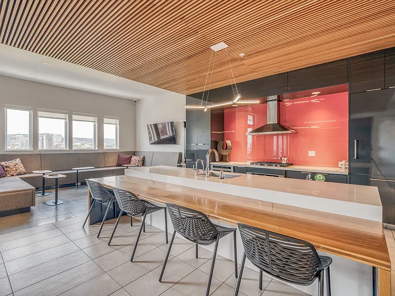 Clubroom and seating area with complimentary Wi-Fi, bar, and kitchen