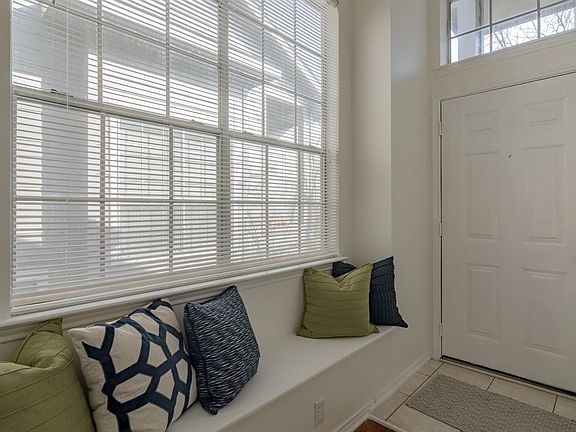 Built-in window seat adds charm to this bright foyer.