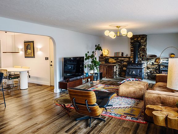 Living room has a wood burning stove and closet to store wood.
