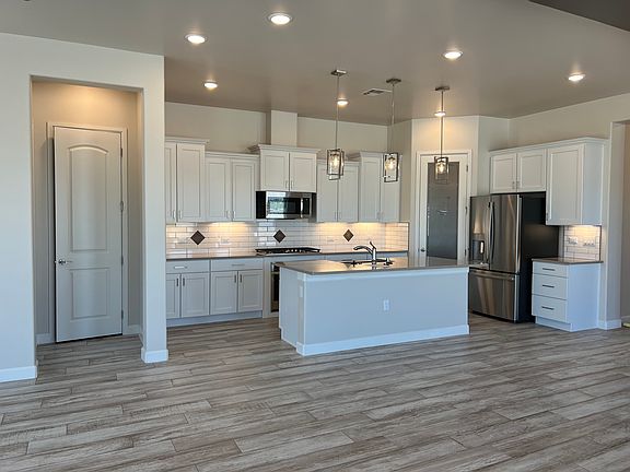 Large kitchen with open dining room/living room area for entertaining or relaxing.