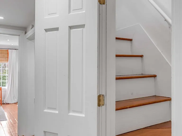 Stair case to fourth floor guest bedroom , located in hallway between the Master bedroom and third floor guest bedroom.