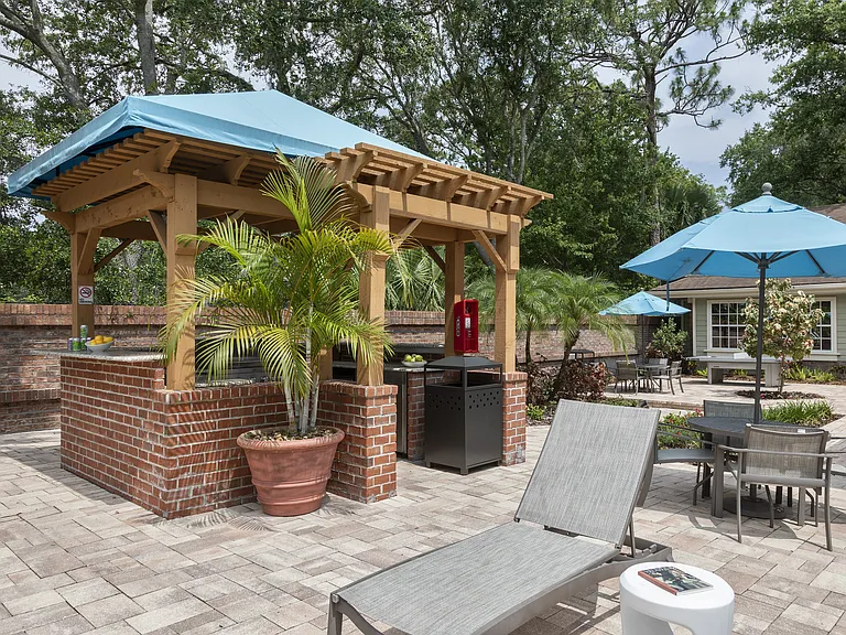 Poolside chef's kitchen and outdoor dining area