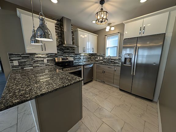 Kitchen Stainless Appliances with dishwasher and fridge with ice dispenser