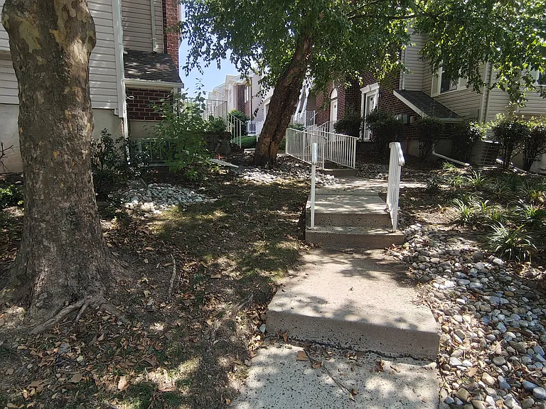Beautifully kept front walkway offering an inviting approach to the home's entrance.