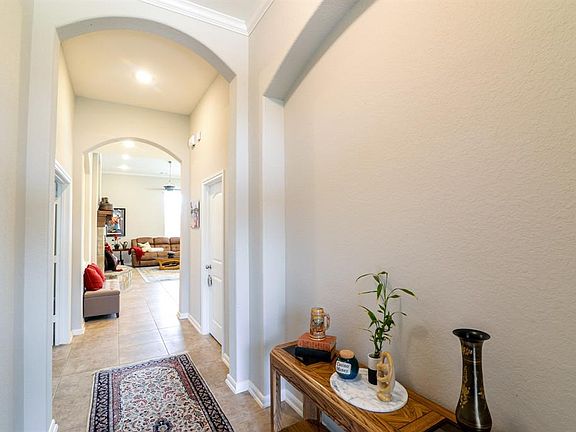 Enter your front door and check out the Ceramic Tile Floors, and the Arched Sheetrock openings.