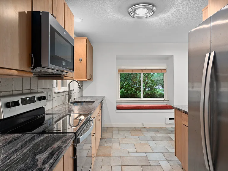 Walkthrough Kitchen with stainless steel appliances, cabinet underlighting, plenty of counter and cabinet space