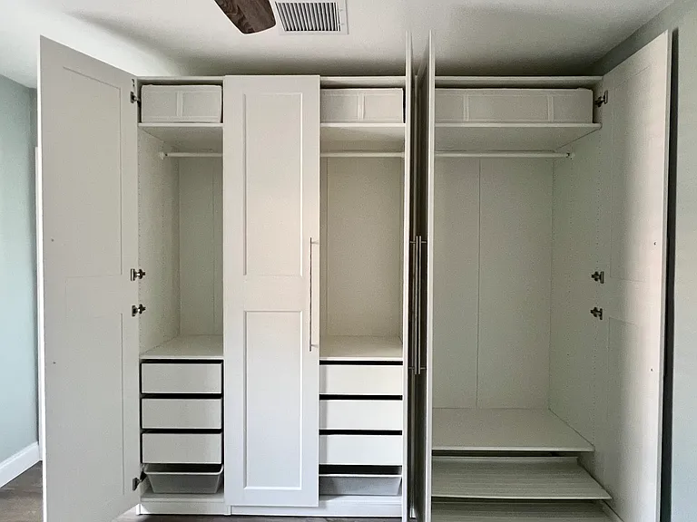 Designed for both style and function, this custom built-in closet includes drawers, slide-out shelving, and organized compartments_perfect for maximizing space and keeping everything neatly in place.