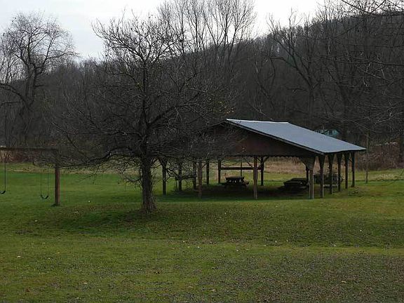 The swings on the left and the Pavillion, which includes three picnic tables.