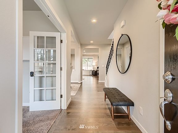 Enter to the beautiful finishes!  Den on the left with french doors