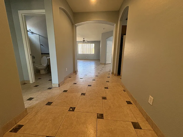 Foyer with Mother-in-law suite to the left and Kitchen to the right and Living areas straight ahead.