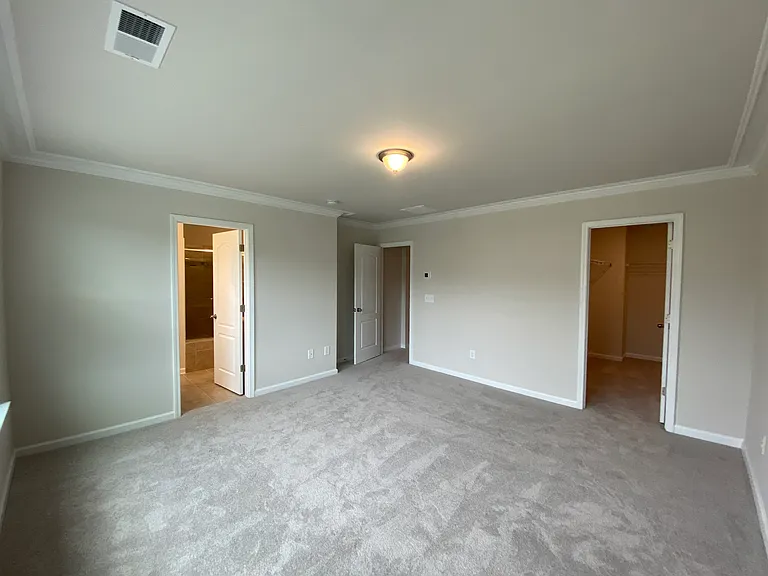 Master bedroom, looking at entrance, closet and bathroom doors.