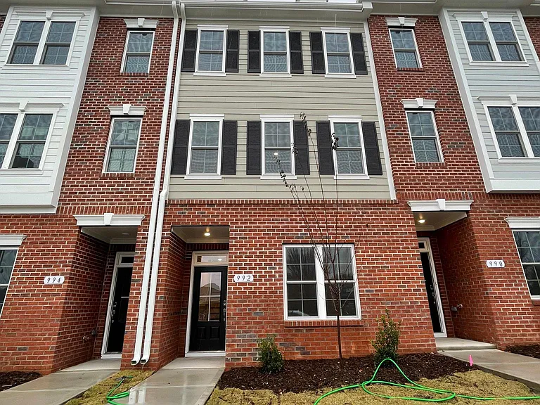 Partial Brick front with small yard and plenty of windows for natural light