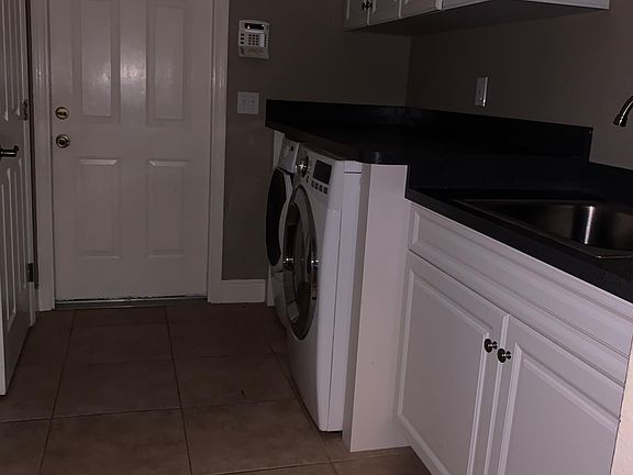 Indoor Laundry room with sink and large storage closet