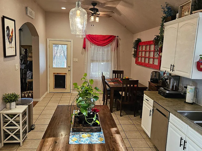 Eat-in kitchen with ample cabinet storage, generous counters, and a dedicated dining area near the back door.