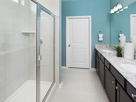 Luxury Owner s Bath with dual vanity and tile shower