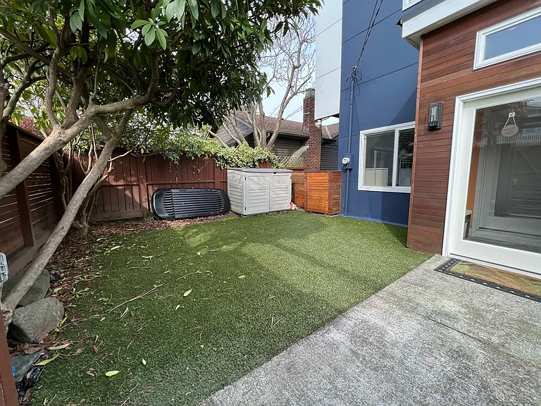 Other side of yard with storage box. Privacy and security with gate. Separate small mud room entrance to house.