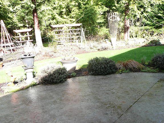 Outside the back door is a large concrete patio, perfect for