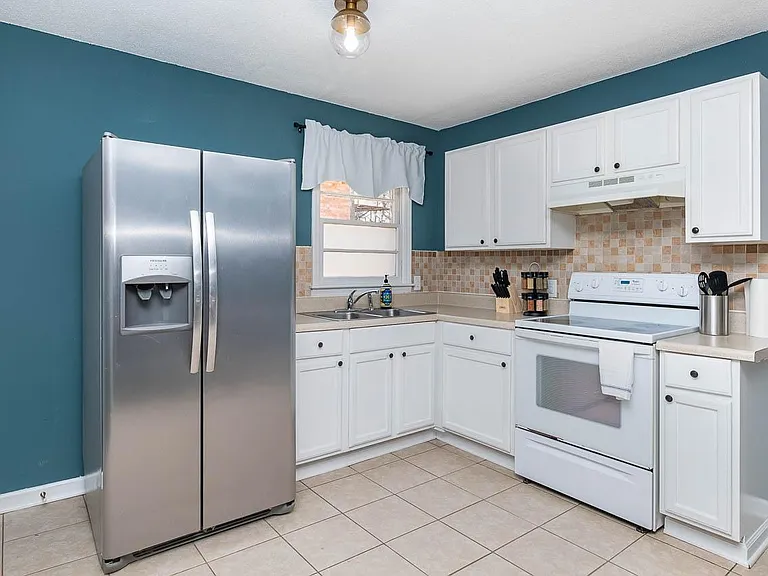 Kitchen fully stocked with every dish you could need.