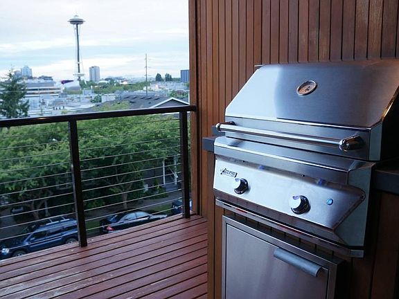 Built-in gas grill on covered deck, overlooking Space Needle