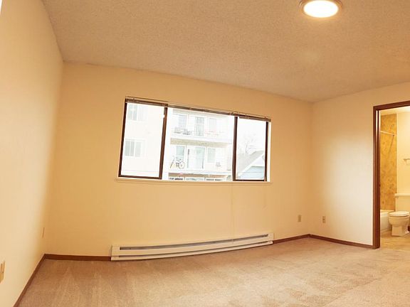 View of kitchenette, windows, and full bath
