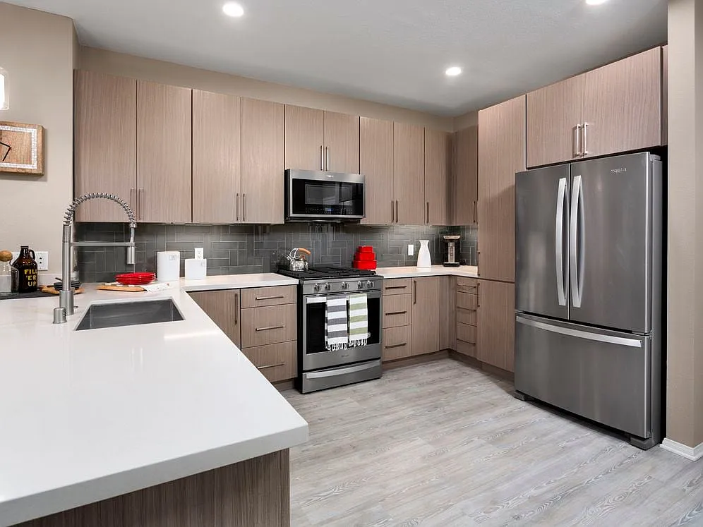 Design Scheme II Kitchen with quartz countertops, stainless steel appliances, and hard surface plank flooring - Avalon Studio City
