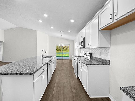 Your bright, open kitchen includes granite, 36-inch cabinets, a walk-in pantry, and Samsung applianc