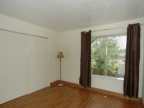 ONE OF TWO SECONDARY BEDROOMS WITH WOOD FLOORING