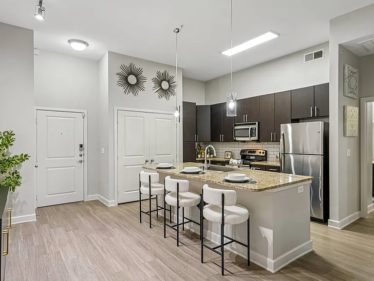 Experience open-concept kitchen designs with premium appliances at Addison Keller Springs apartments in Addison, TX.