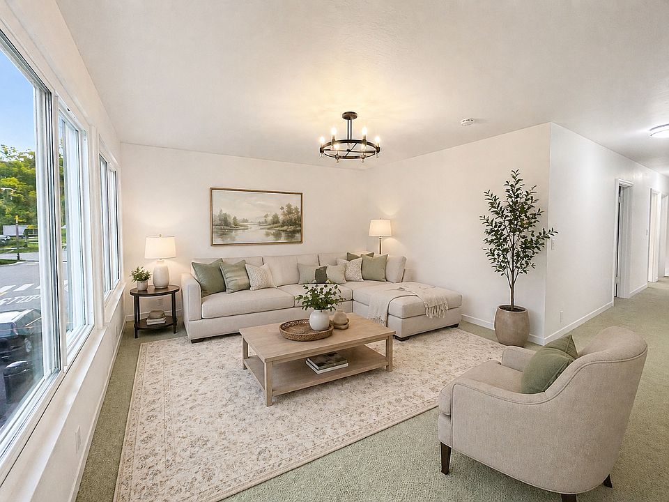 Large lightfulled living room with new carpet - Virtually Staged