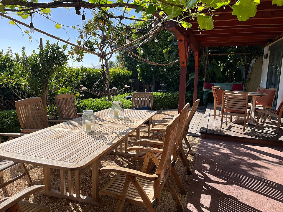 Private Backyard with Teak Tables, BBQ Area, Love Seat Swing, Granite California Gold Gravel, patio and Redwood deck.
