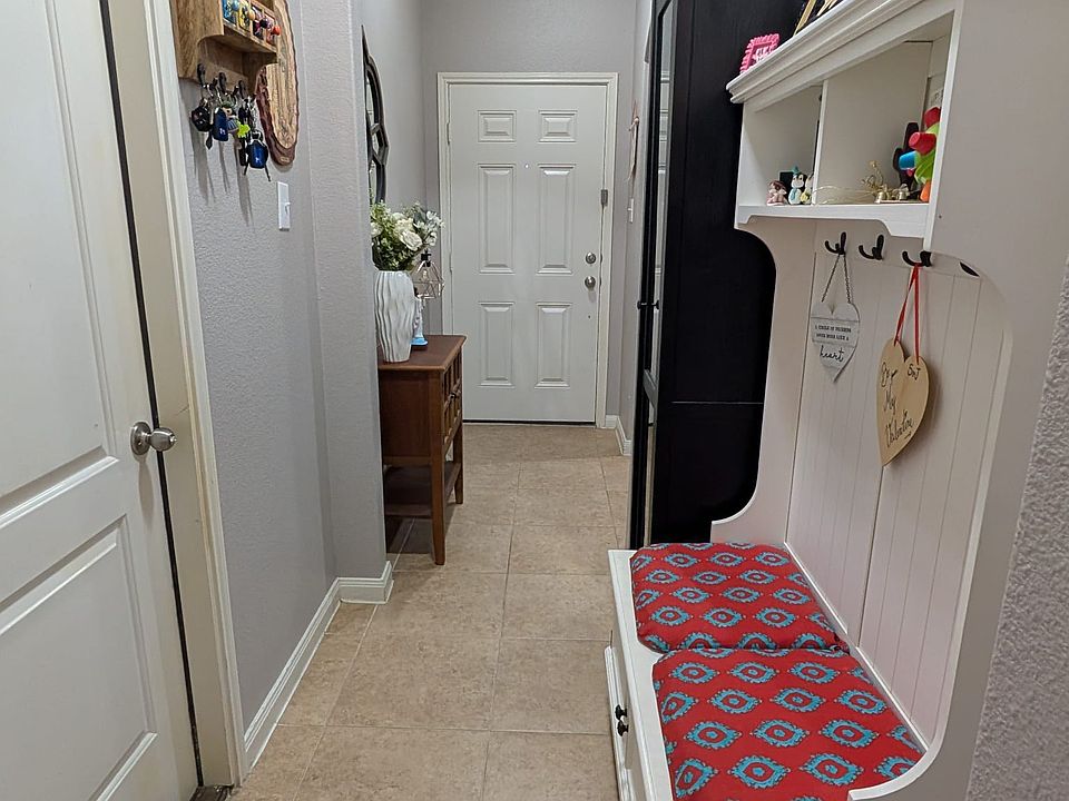 Hallway leading to the front door and the garage door.